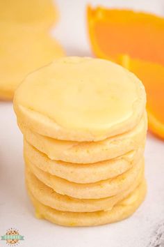 a stack of cookies sitting next to an orange slice