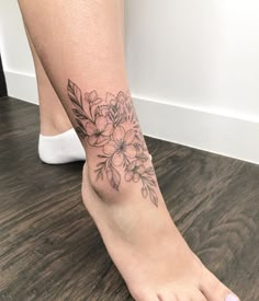 a woman's foot with flowers on it