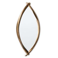 a mirror that is on top of a white wall with a gold leaf decoration around it