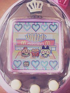 a close up of a nintendo game in a plastic container on a wooden table with hearts