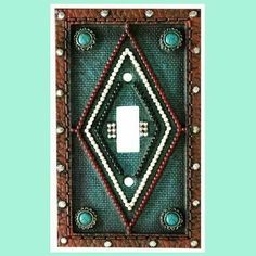 a decorative light switch cover with beaded accents