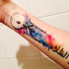 a person's arm with a tattoo on it that has an image of a man riding a bike