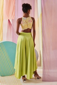 Hand dyed butter yellow halter neck crop top with statement vibrant glass beads, rain-drop pearls and tasselled floral hand embroidery. Paired with hand dyed lime green satin draped palazzo pant. - Aza Fashions Festive Sleeveless Summer Crop Top, Festive Sleeveless Crop Top For Summer, Fitted Yellow Bottoms For Festive Occasions, Fitted Yellow Bottoms For Festive Season, Festive Summer Crop Top, Crop Top With Palazzo, Top With Palazzo, Floral Hand Embroidery, Womens Palazzo Pants