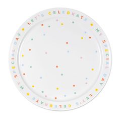 a white plate with multicolored letters and stars on the rim that says let's celebrate my birthday