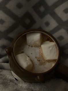 marshmallows in a mug on a blanket