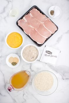 the ingredients to make this dish are laid out on a marble counter top