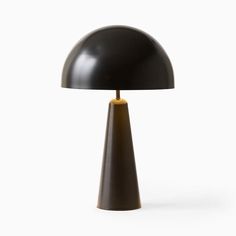 a black table lamp with a gold base on a white background in the shape of a cone