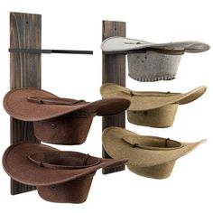 three hats are hanging on a wooden rack