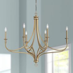 a gold chandelier with six lights hanging from it's center and two sides