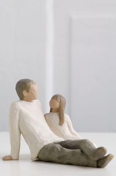 a figurine of a man and woman sitting next to each other