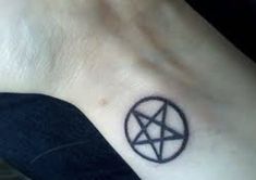 a small pentagramil tattoo on the ankle