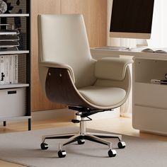 a white office chair sitting in front of a computer monitor on top of a desk