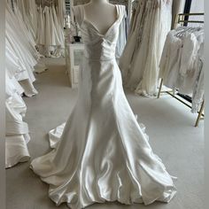 a white wedding dress on display in a store