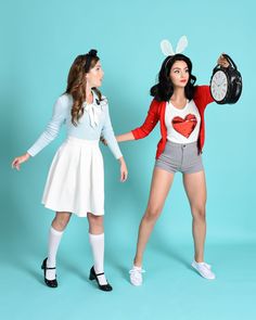 two women dressed in bunny ears, one holding a clock and the other standing up