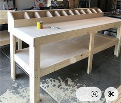 a workbench is being constructed with plywood and paint on the table top