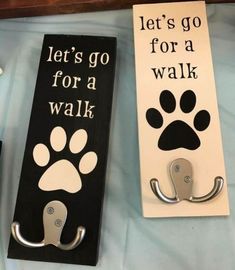 two door hangers that say let's go for a walk and dog paw