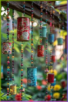 colorful tin can wind chimes hanging from a tree