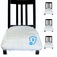 four black chairs with white pillows and one has a blue logo on the seat cushion