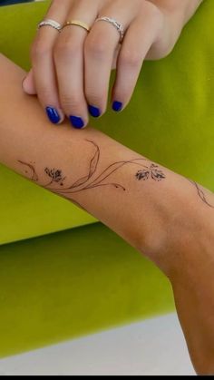 a woman's arm with flowers on it