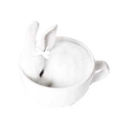 a white cup with a bunny in it