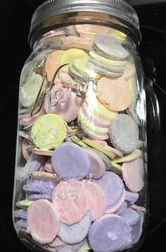 a jar filled with lots of different colored candies