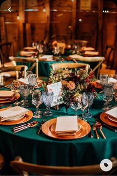 the table is set with plates and place settings