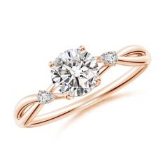 a rose gold engagement ring with two pear shaped diamonds on the band and an accent diamond in the center