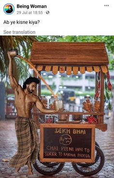 a man standing in front of a food cart