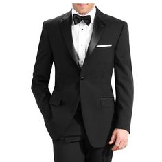 a man in a tuxedo is posing for the camera with his hands in his pockets