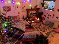 a bed room with lots of pillows and blankets on the floor next to a mirror