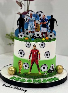 a three tiered cake decorated with soccer players