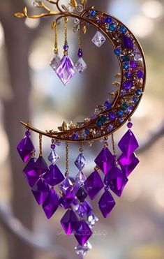 a close up of a wind chime with purple and blue beads hanging from it's side