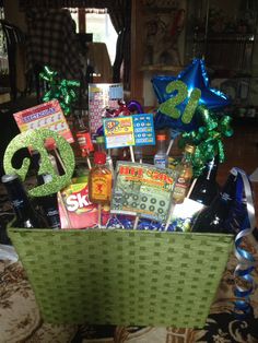 a birthday gift basket filled with liquor and confetti for someone's 50th