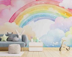 a child's room with a rainbow wall mural