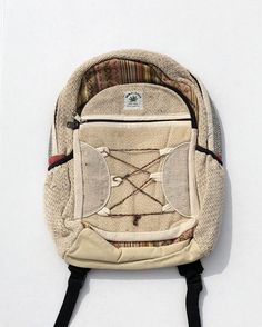 All natural hemp backpack. Great for outdoor use, school, traveling, and day-to-day activities. This unisex, high quality, hemp backpack features multi color panels trimmed in Natural color Hemp Fabric. It is an ethical, sustainable, eco-friendly alternative to synthetic and leather backpacks, featuring 100% wild hemp exterior lined with heavy duty cotton. Hemp is an eco-friendly, antimicrobial alternative to your typical everyday fabrics. 14 in wide by 17 tall. No two are exactly alike and colo Casual Rectangular Backpack For Adventure, Beige Rectangular Backpack For Outdoor, Casual Beige Backpack For Outdoor Activities, Bohemian Backpack In Natural Color For Everyday Use, Bohemian Style Natural Color Backpack For Everyday Use, Beige Standard Backpack For Outdoor, Casual Adventure Backpack, Eco-friendly Bag With Adjustable Strap For Outdoor, Handmade Natural Backpack For Everyday Use