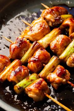 chicken and vegetable skewers are being cooked in a skillet