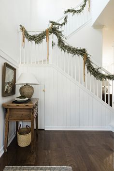 a christmas garland is hanging on the banister