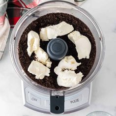 a food processor filled with white and brown ingredients