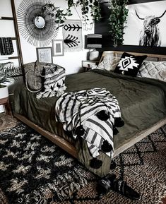 a bedroom with black and white decor on the walls, rugs and bedding