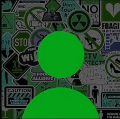 two green circles are in front of a wall with various stickers and signs on it