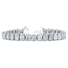 Indulge in luxury with this stunning 7-inch Tennis Bracelet crafted in platinum, featuring a dazzling array of GIA certified oval diamonds. Each oval diamond is meticulously set in a basket claw prong setting, ensuring maximum security and showcasing their brilliance to perfection. With a combined total carat weight of 31 carats, these oval diamonds exhibit a range of Color from D to F and a Clarity Grade ranging from VVS2 to VS2, attesting to their exceptional quality and rarity. Each diamond r Luxury Diamond Oval Link Jewelry, Luxury Oval Diamond Bracelet With Jubilee Band, Luxury Oval Jeweled Jewelry, Luxury Diamond Bracelet With Oval Gold Chain, Luxury Romantic Oval Jewelry, Oval Tennis Bracelet Diamond, Oval Diamond Bracelet, Most Expensive Jewelry, Expensive Jewelry Luxury