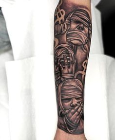 a man's arm with tattoos on it and two women covering their faces behind him