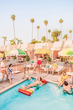 people are sitting around in the pool with lounge chairs and umbrellas on either side