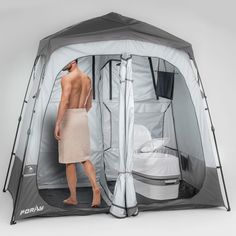 a man standing in front of a portable shower