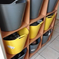 several bins are lined up on the wall