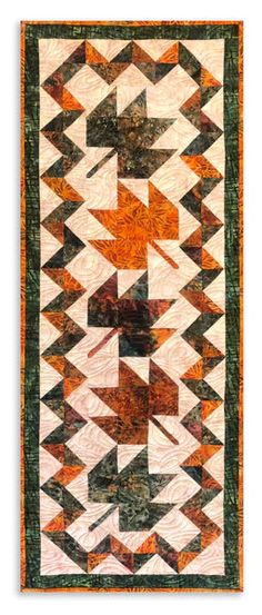 an orange and black quilt with many different designs on it's sides, including arrows