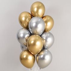 a bunch of metallic and gold balloons in the shape of a pyramid