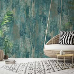 a swing chair in front of a wallpapered background with palm trees and plants