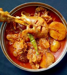 a bowl filled with meat and vegetables on top of a table