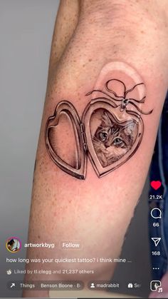 a cat in a heart tattoo on the arm